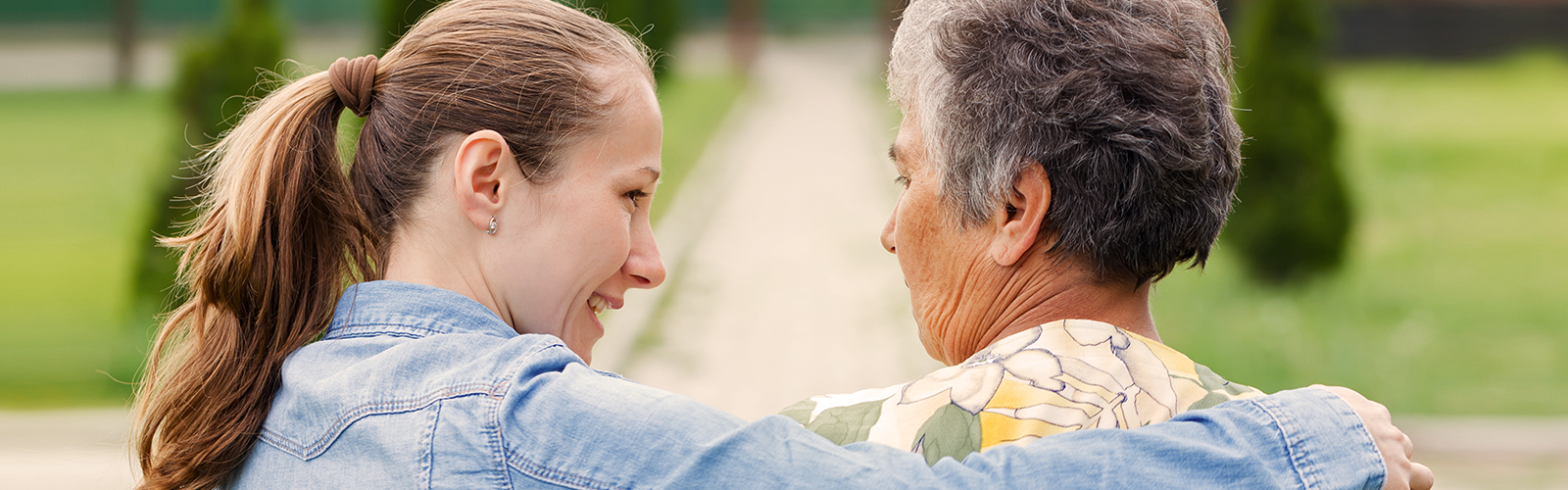 Older woman sitting outside with younger woman Older woman sitting outside with younger woman
